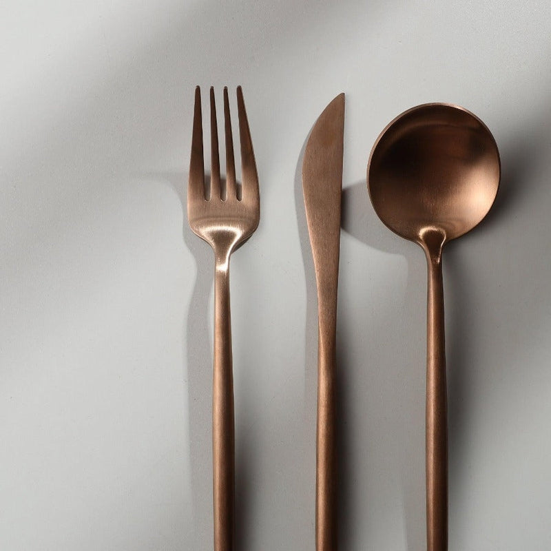 Rose gold PureSet flatware, enhancing your modern dinnerware. Minimalist elegance.