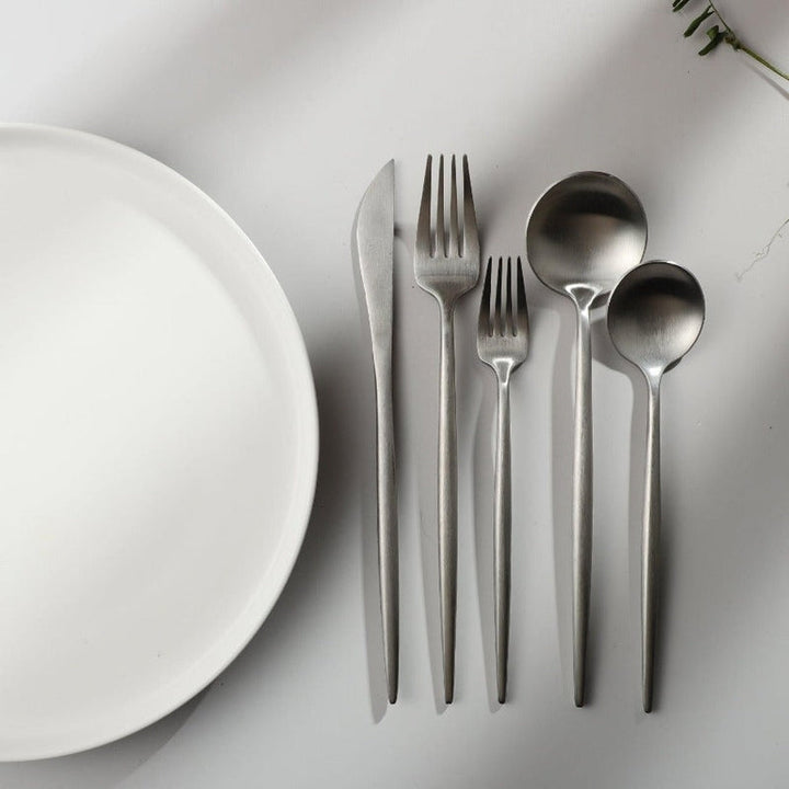 Matte black elegant cutlery set for sophisticated table presentation. Kitchenware.