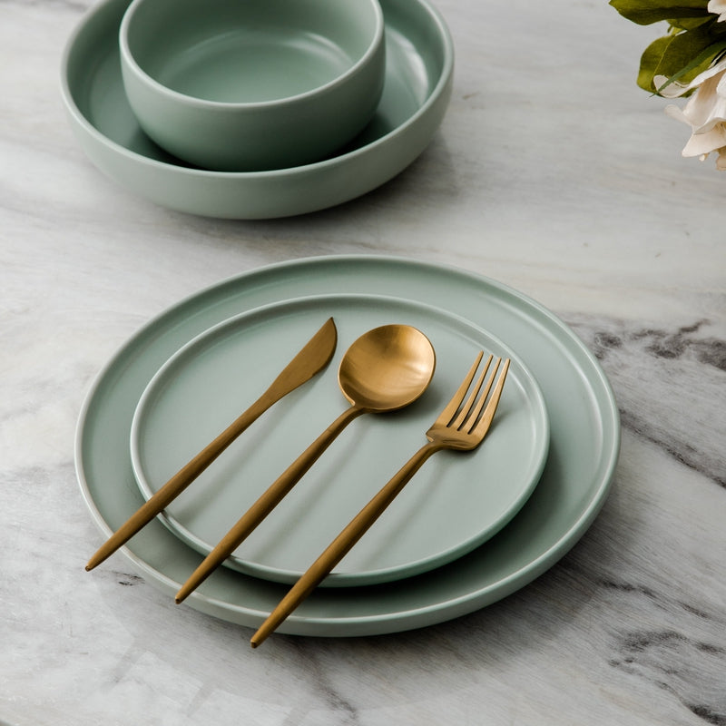 Gold elegant silverware set, perfect for entertaining guests. Luxurious dining decor.