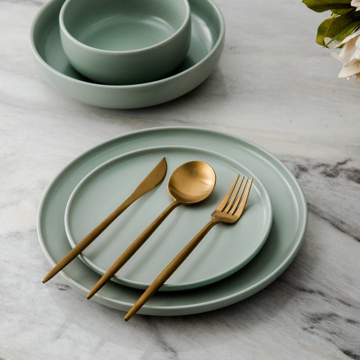 Gold elegant silverware set, perfect for entertaining guests. Luxurious dining decor.
