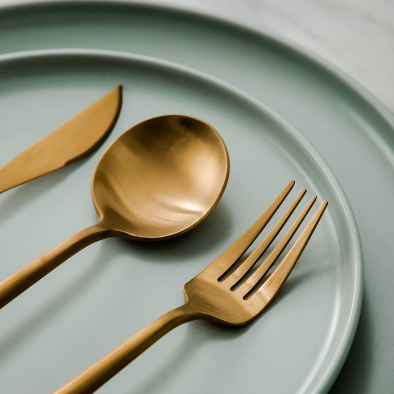 Rose gold minimalist dining set with sleek design. Modern tableware for home decor.