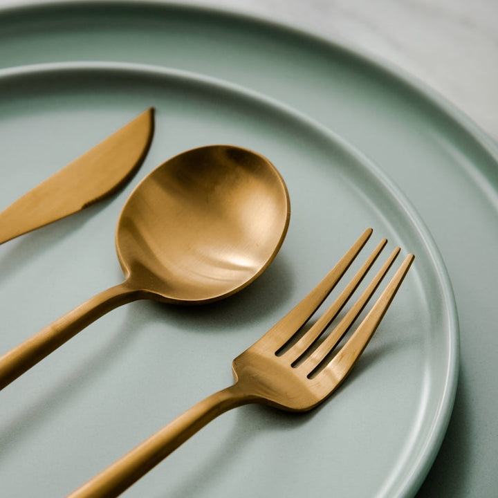 Rose gold minimalist dining set with sleek design. Modern tableware for home decor.
