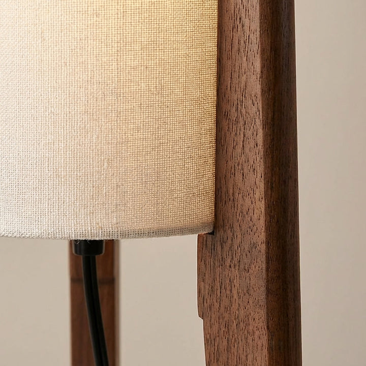 Ambient Havenara floor lamp casting a warm glow in a modern Scandinavian living room setting.