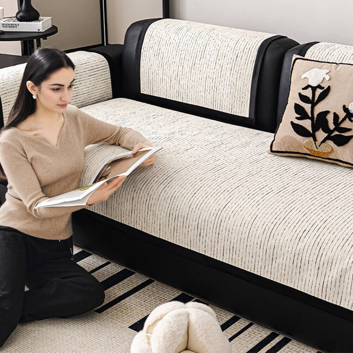 Corner view of a modern striped chenille couch cover, neatly fitted on a sofa