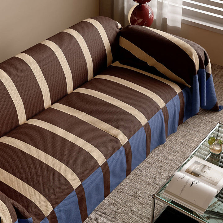 Geometric striped sofa cover enhancing home decor, providing a fresh and modern look to a couch.