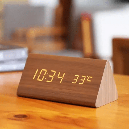 Modern wooden LED digital alarm clock with voice activation for minimalist home decor.