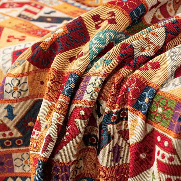 Geometric woven throw blanket in Moroccan style, enhances sofa and bed as a decorative cover.