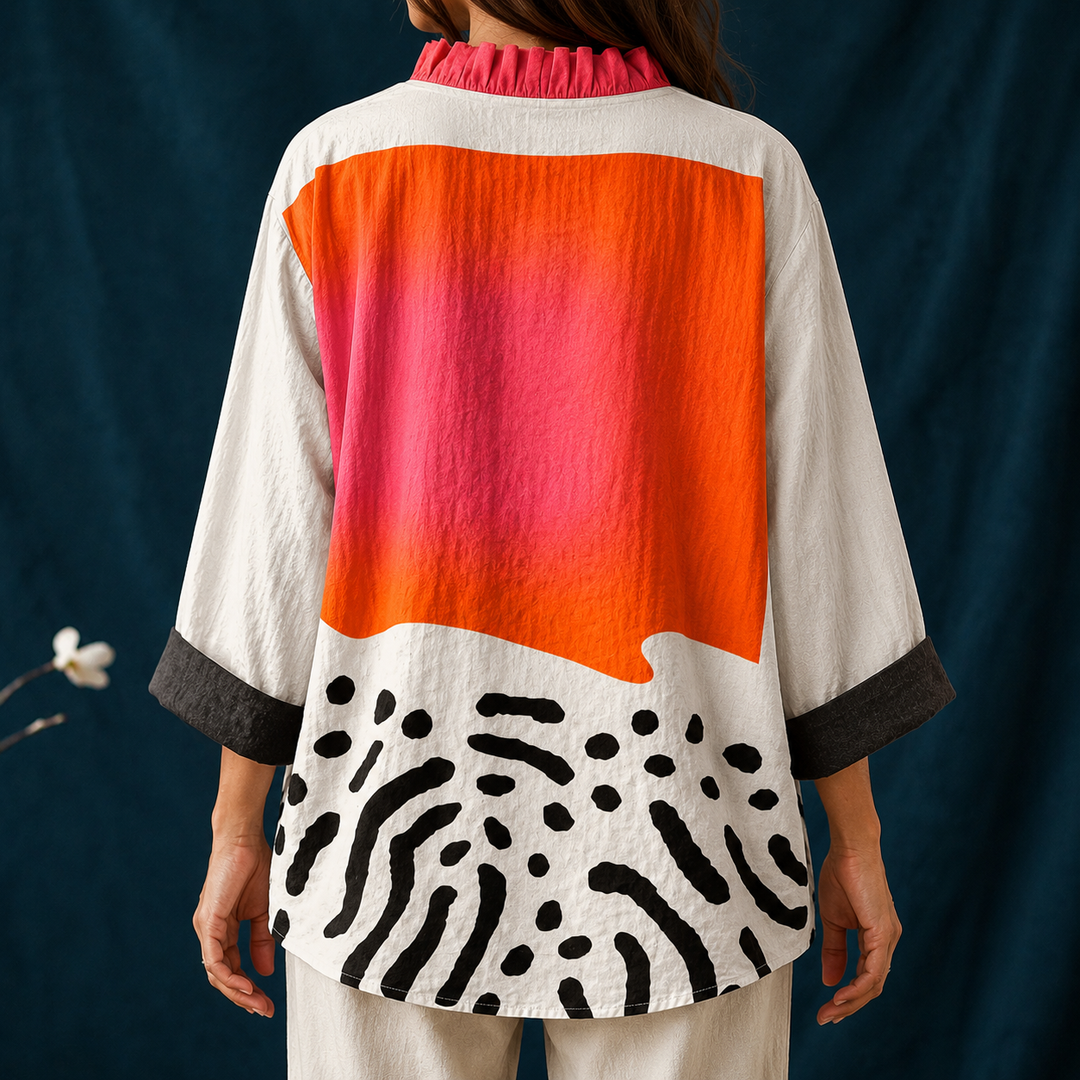 Fashionable women's abstract block button-up blouse with a ruffled collar, long sleeves, and a vibrant multicolor pattern.