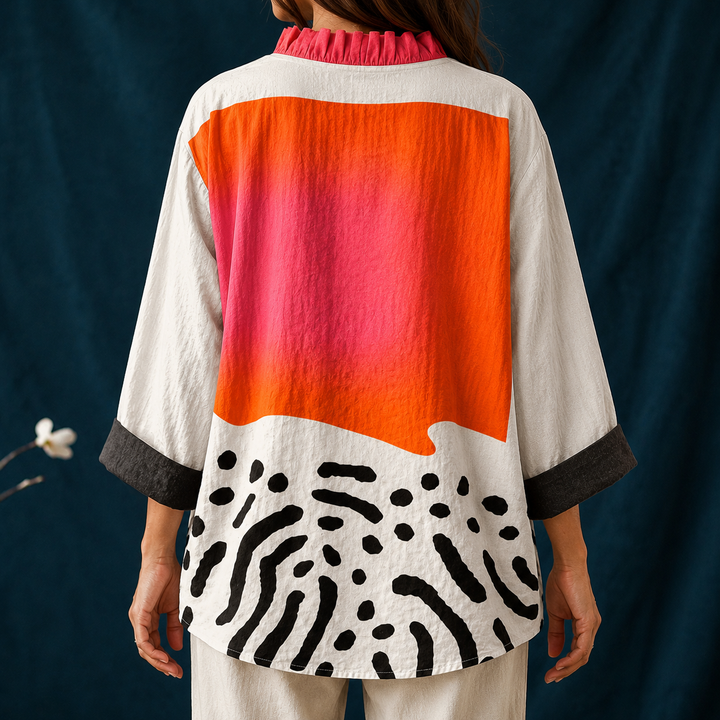 Fashionable women's abstract block button-up blouse with a ruffled collar, long sleeves, and a vibrant multicolor pattern.