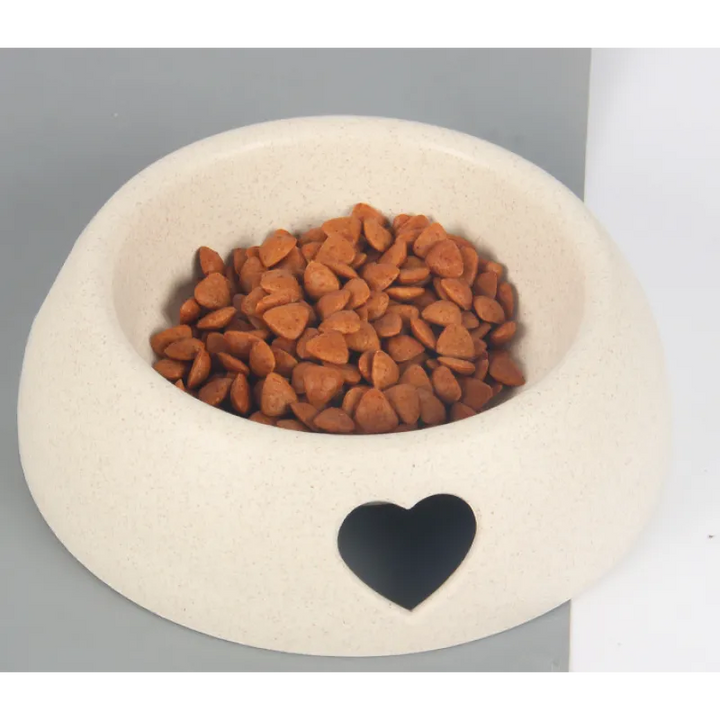 Heart-shaped design pet feeding bowl in natural wood finish, ideal for health-conscious pet owners.