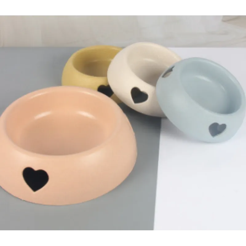Stylish pet feeding dish with a heart cutout, crafted from durable natural and renewable materials.