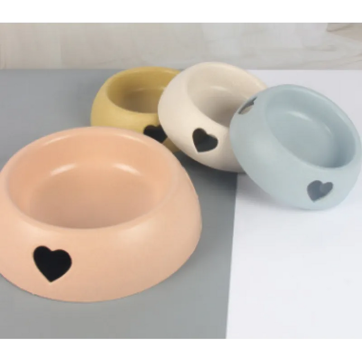 Stylish pet feeding dish with a heart cutout, crafted from durable natural and renewable materials.