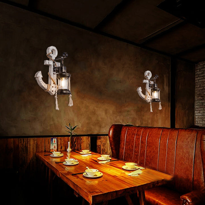 Seaside style Anchor LED Wall Sconce. Iron fixture, rustic wood finish, provides warm lantern glow for coastal homes.