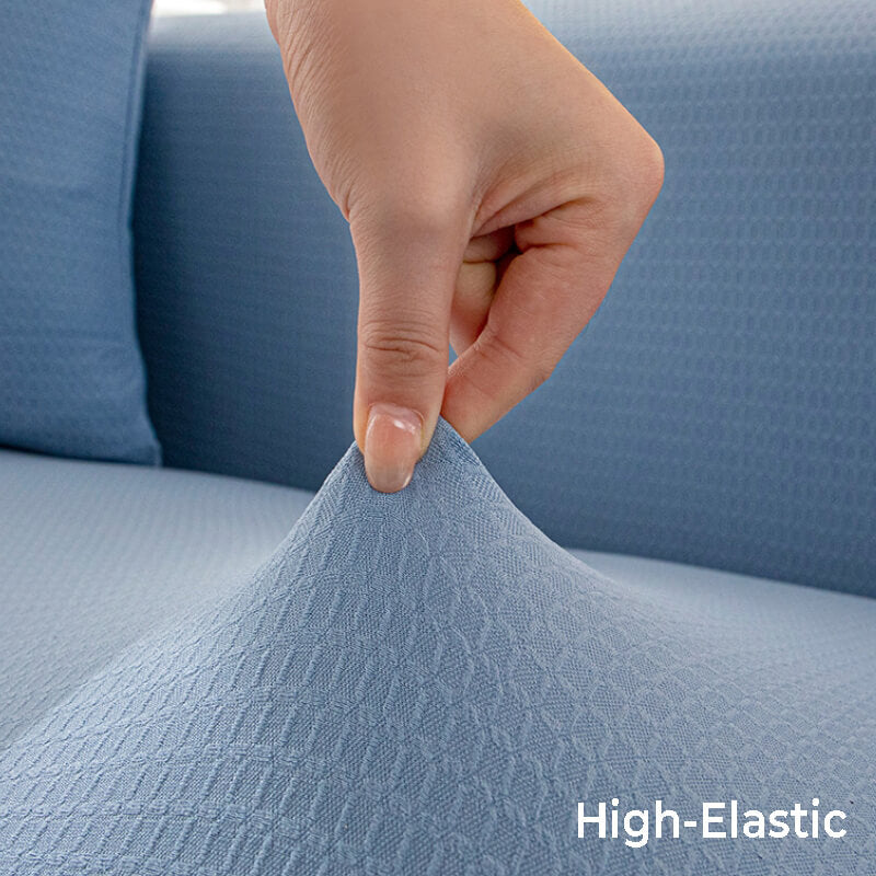 Light gray stretchy couch cover on a two-seat sofa, showing snug fit and furniture protection
