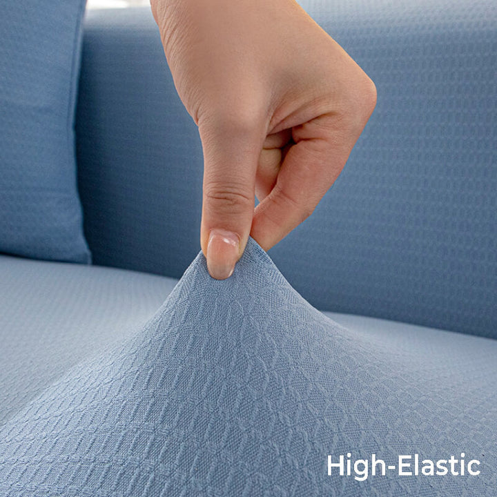 Light gray stretchy couch cover on a two-seat sofa, showing snug fit and furniture protection