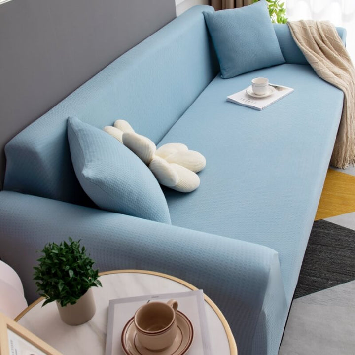 Elastic band detail of a stretch sofa cover ensuring a secure, wrinkle-free fit on furniture