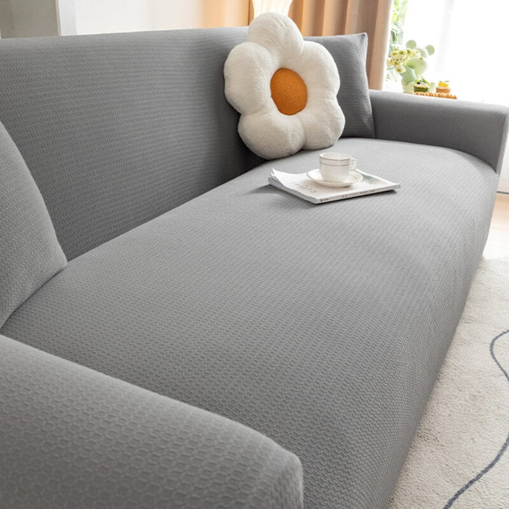 Corner view of a black anti-scratch couch protector, highlighting durable pet-friendly material