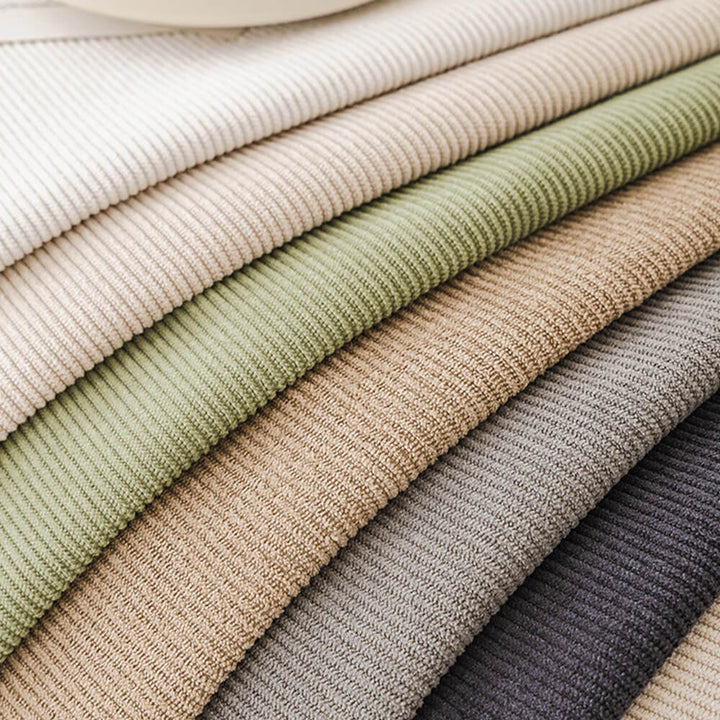 Collection of corduroy couch covers in various colors, all with pom-poms and non-slip features.