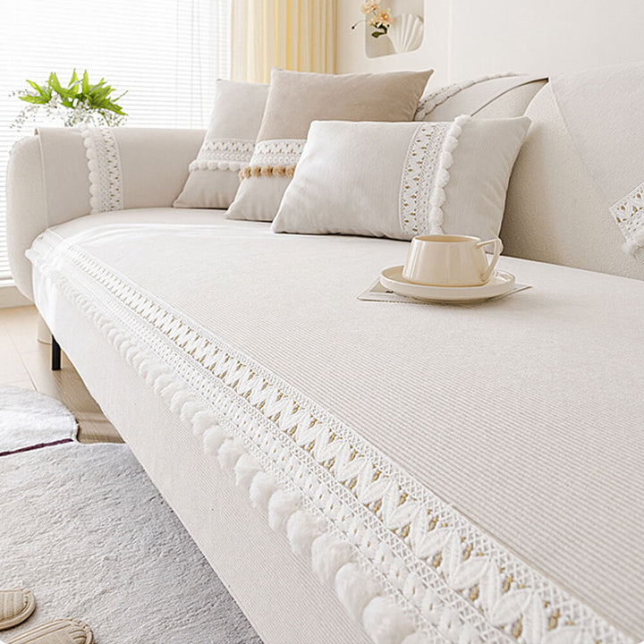 Close-up of the durable, water-resistant corduroy fabric for a couch cover with pom-poms.