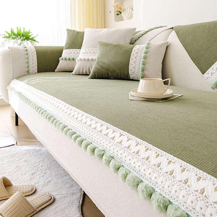 Washable corduroy couch cover for a sectional, featuring elegant pom-poms and pet-friendly design.