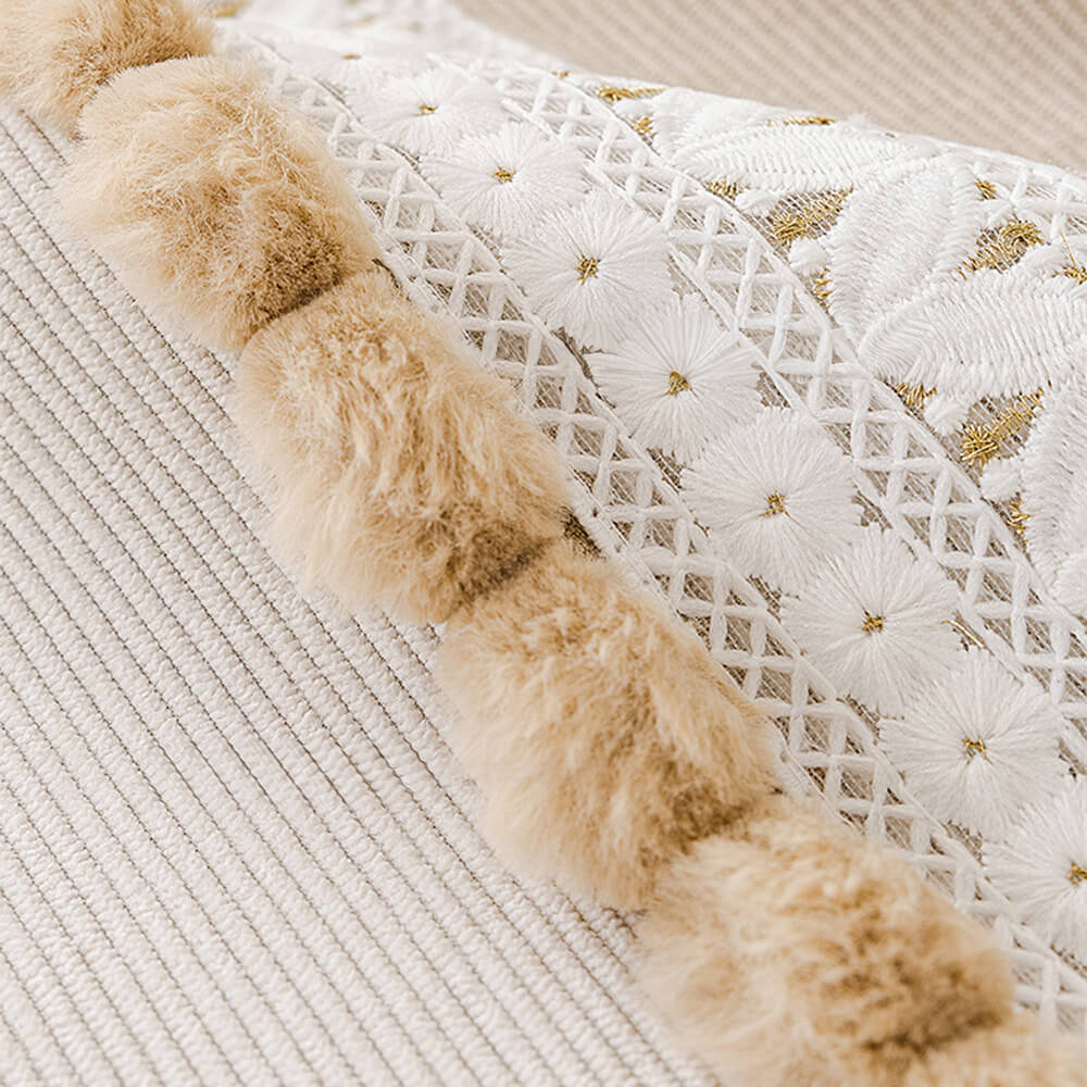 Full view of a living room with a brown corduroy couch cover, pet friendly, with pom-poms.