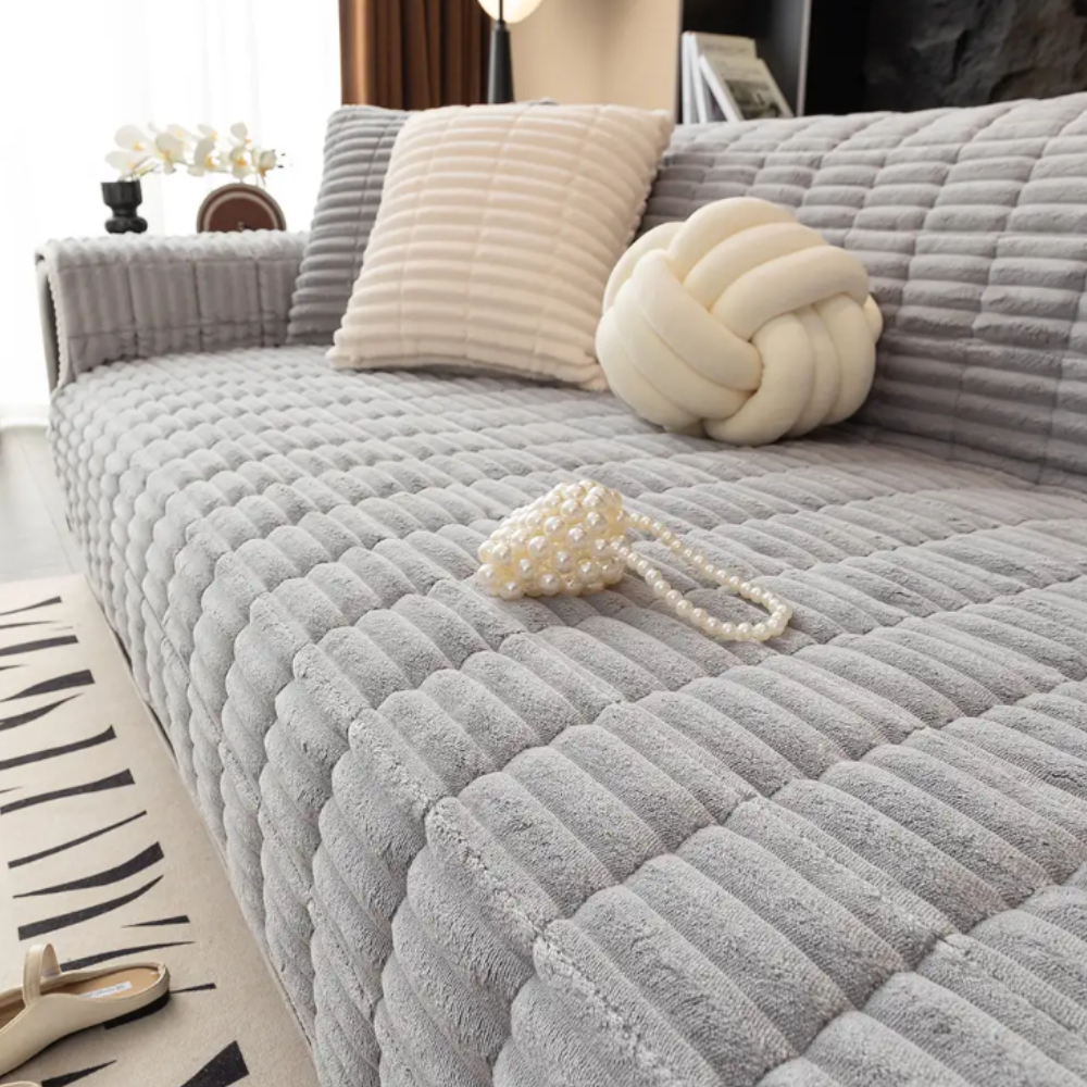 Flannel sofa cover on a three-seater couch, highlighting full coverage and easy care home decor.