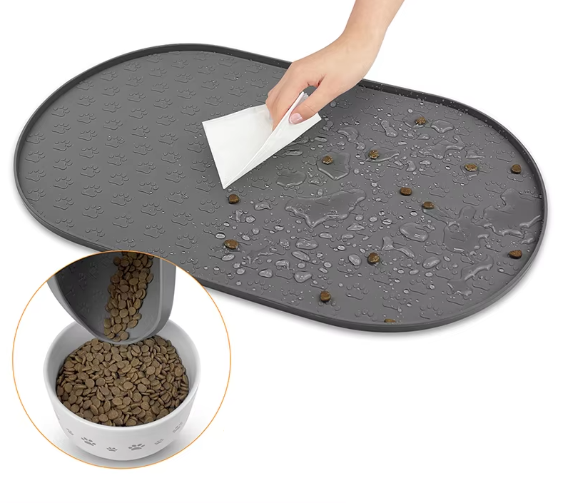 Dog feeding accessory: non-slip, easy-clean mat with raised outer rim for spill protection, black.