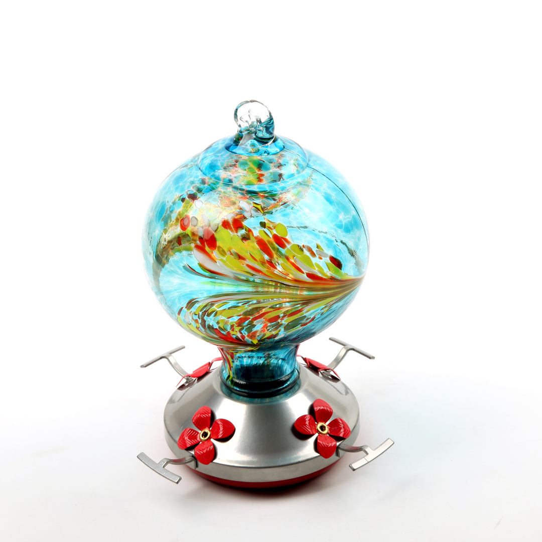 Ocean Blue Hand Blown Glass Hummingbird Feeder with a hummingbird mid-flight, enhancing garden decor