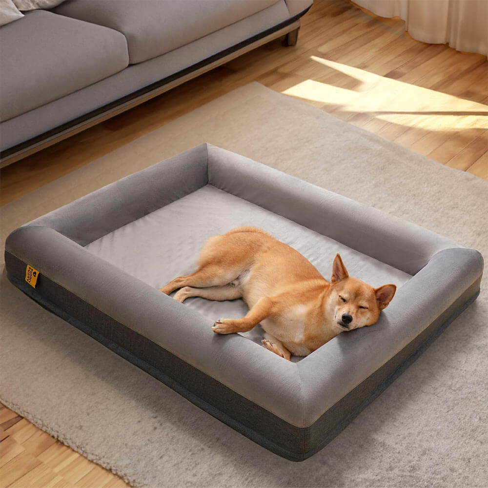 Orthopedic dog bed with plush grey suede for joint support & comfort.