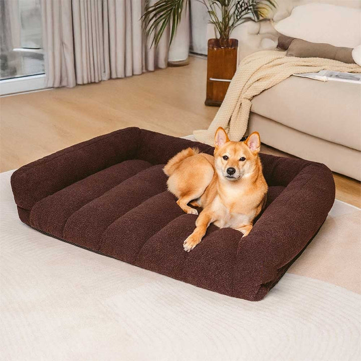 Orthopedic dog sofa bed with soft teddy fleece headrest, promoting joint support for pets.