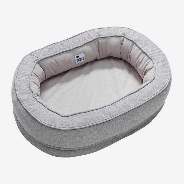 Orthopedic donut dog bed, featuring a raised rim for head and neck support.