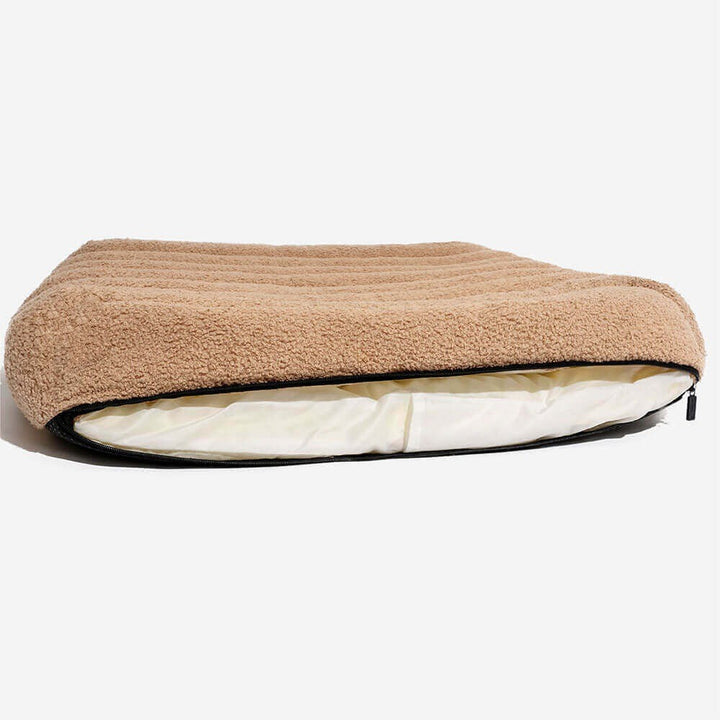Close-up of washable creamy orthopedic dog bed fabric, showing cosy texture