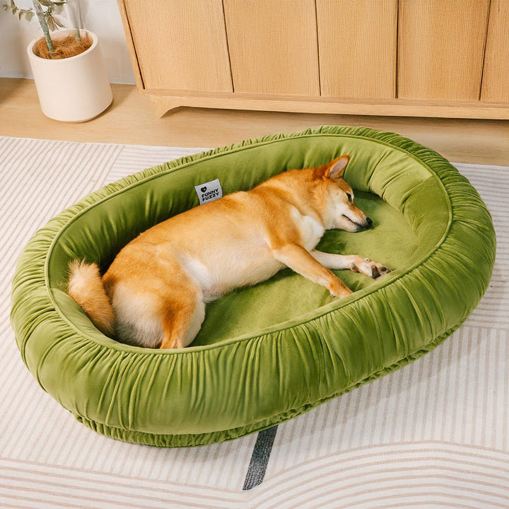 Orthopedic oval pet calming bed with soft velvet, ideal for dogs and cats, featuring a detachable cover.