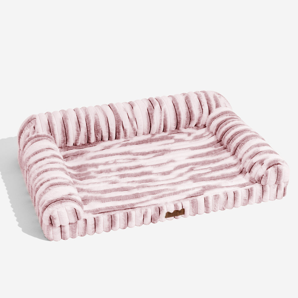 Striped faux fur orthopedic pet bed with bolster, non-slip bottom, provides ultimate pet comfort