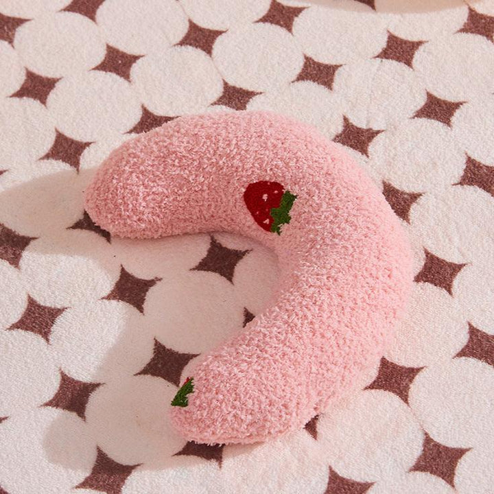 Senior dog sleeping soundly in a supportive orthopedic U-shaped bed, plush and comfortable.