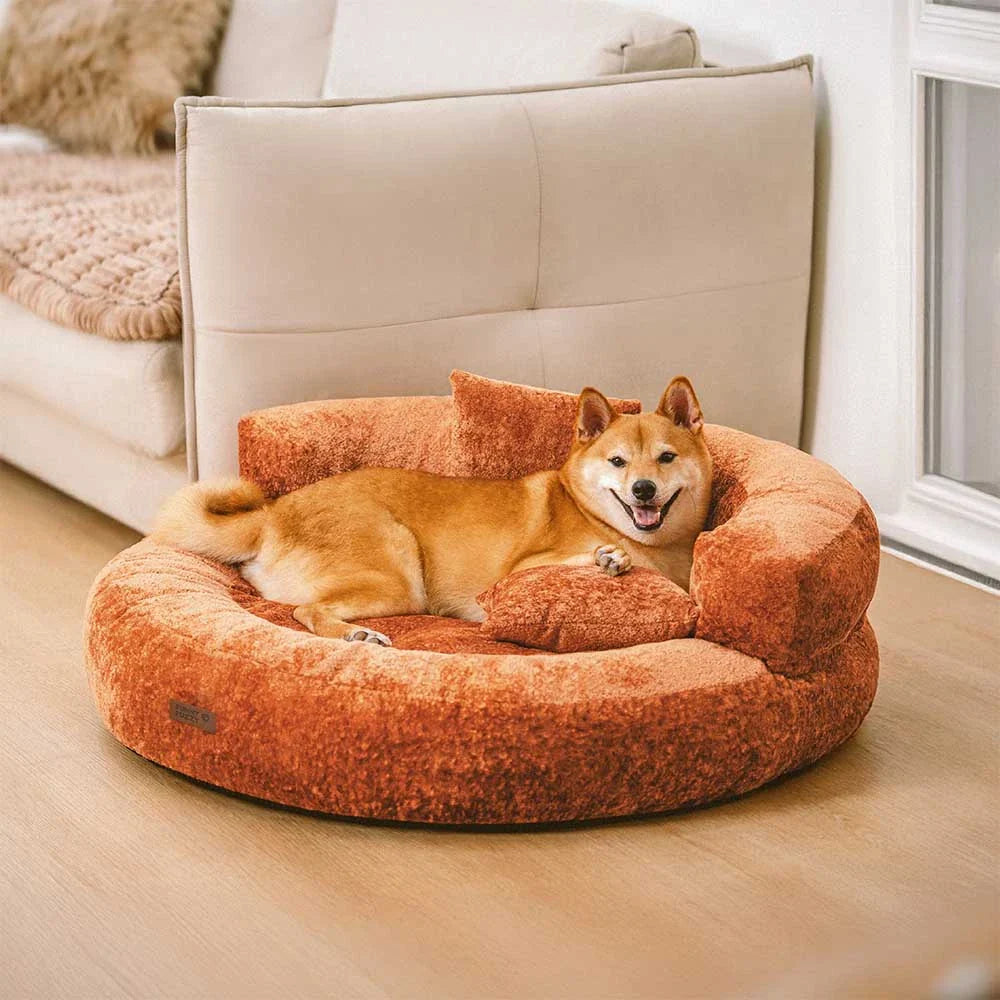 Orthopedic velvet donut dog bed with plush pillows for ultimate pet comfort and joint support.