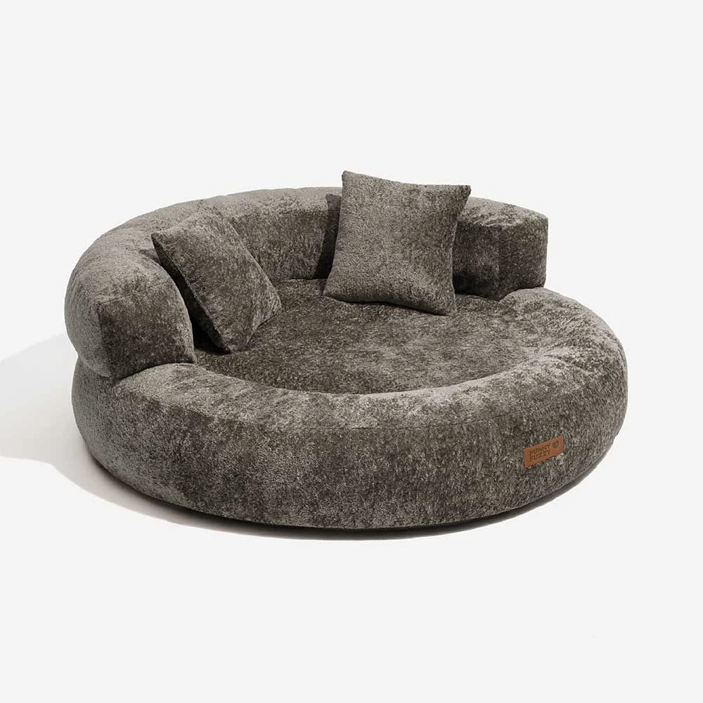 Brown velvet orthopedic donut dog bed with full pillow bolsters, promoting restful sleep.