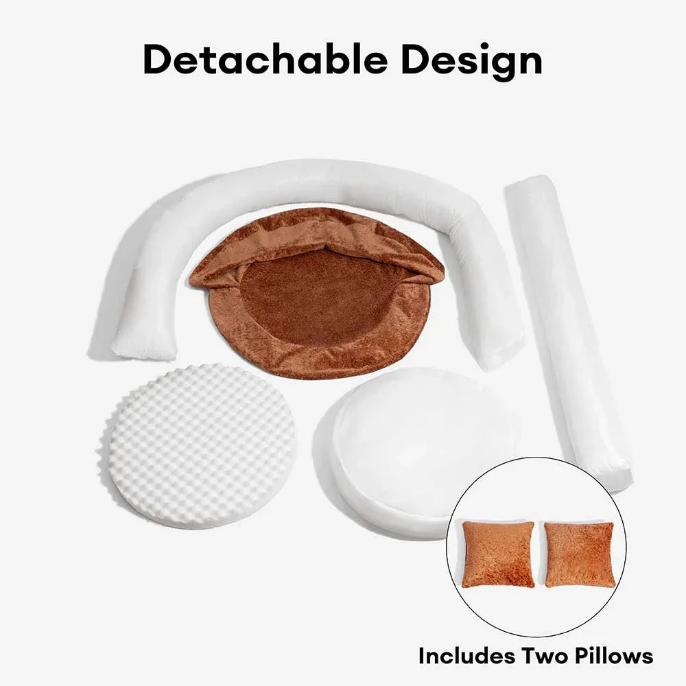 Gray velvet orthopedic pet bed, donut shape with pillow bolsters for head and neck support.