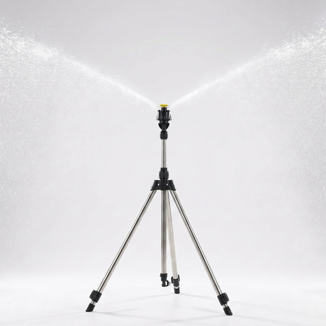 Adjustable tripod lawn sprinkler stand shown watering a large green garden area.