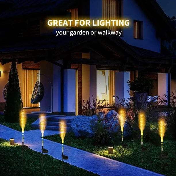 Decorative solar reed lights in a garden bed, adding a warm ambiance to outdoor spaces.