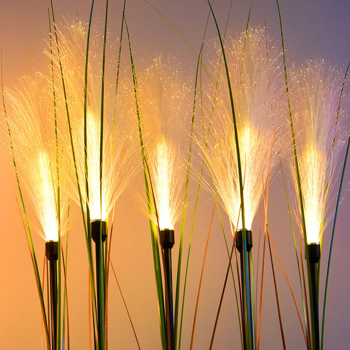 Close-up of solar reed garden light, intricate design, perfect for outdoor pathway lighting.