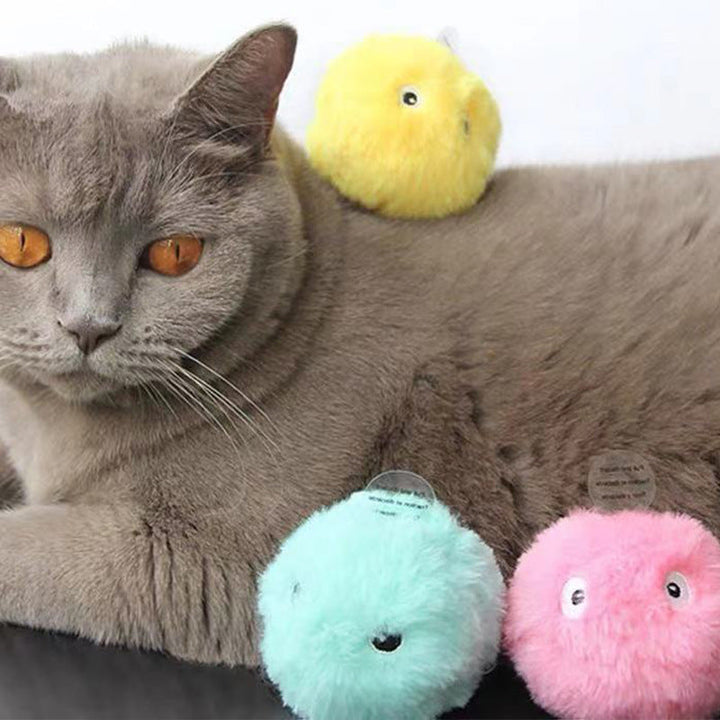 Close-up of cat playing with a soft interactive plush ball that makes animal sounds