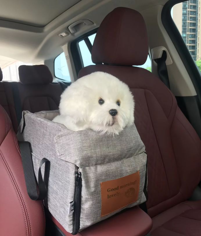 Padded portable dog car seat with safety straps, perfect for secure pet travel.