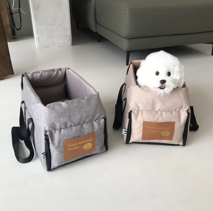Beige dog car seat, padded for comfort, ensures pet safety during car journeys.