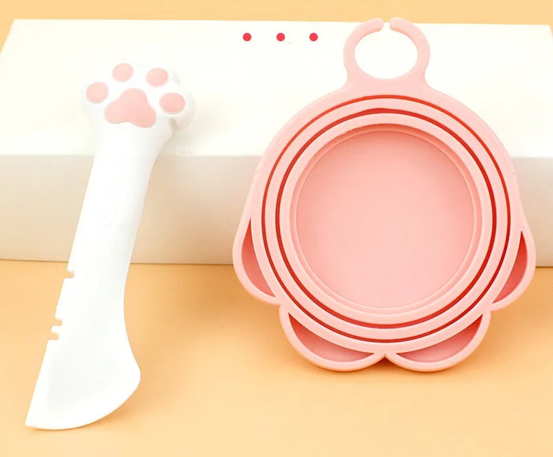 Multi-use silicone paw-shaped pet feeding spoon & can opener, essential pet supply.