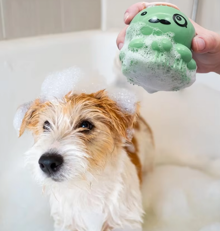 Pet bathing brush with foam dispenser; silicone bristles gently groom dog or cat during bath