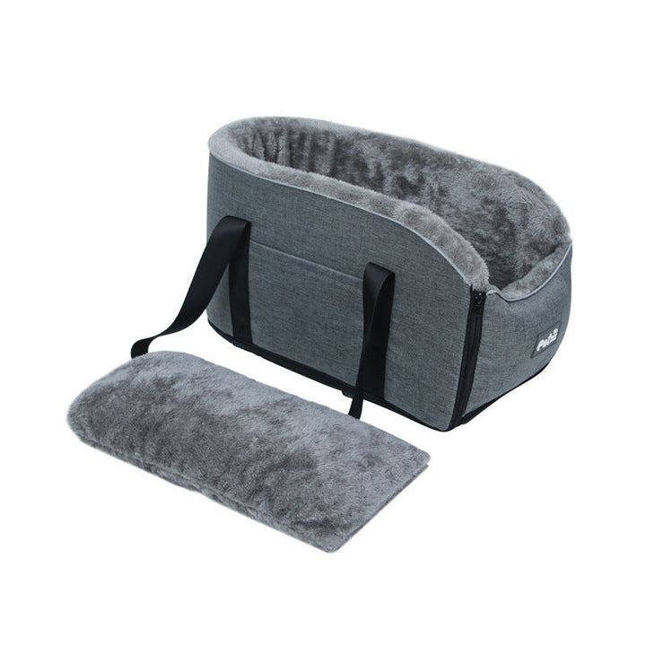 Close-up of pet safety leash attaching to harness in car armrest booster seat for small pets.