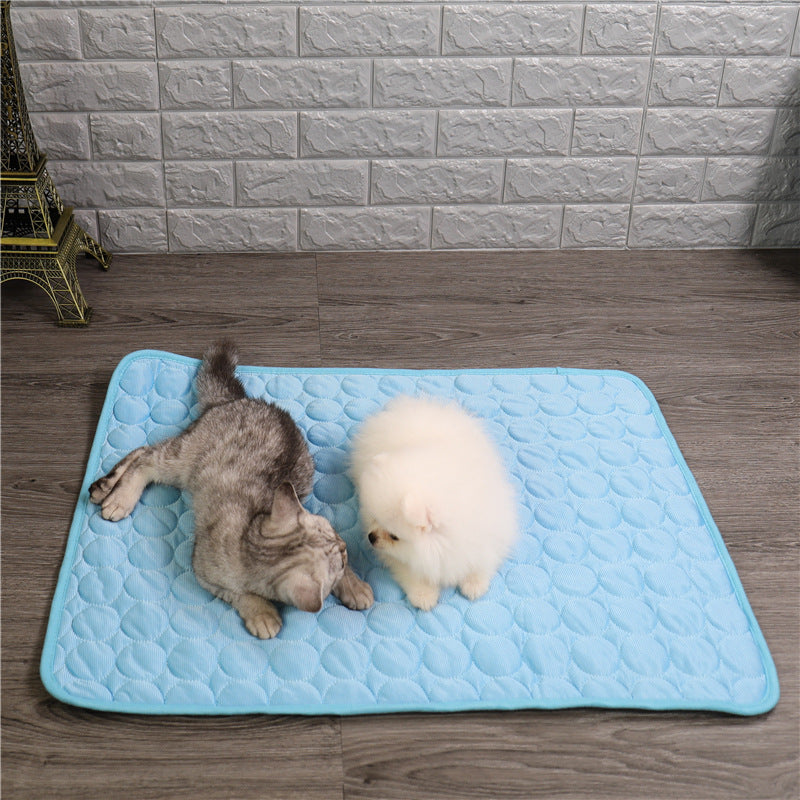 Dog cooling mat, blue square gel pad providing summer comfort for pets, ideal for travel.