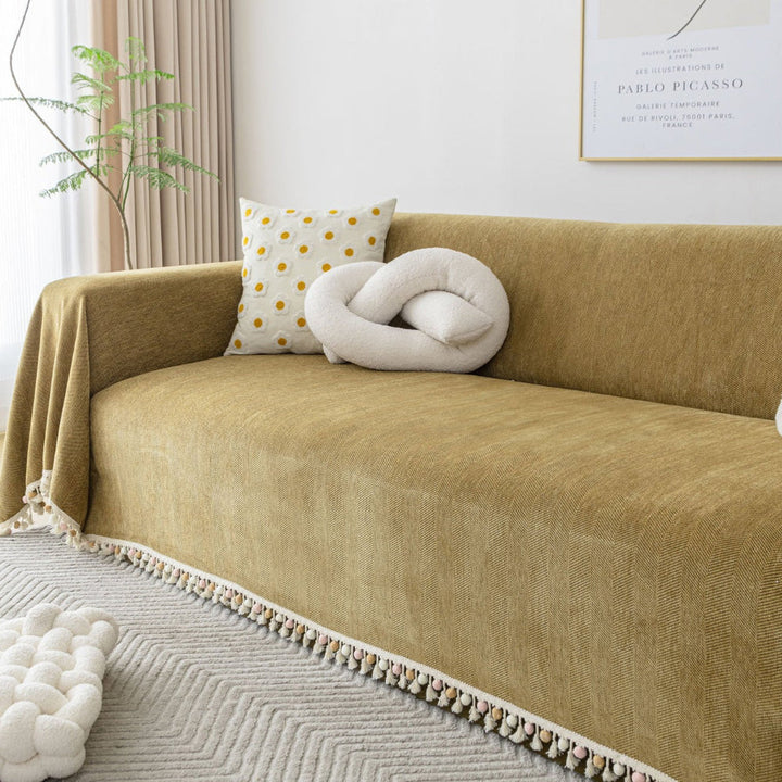 Machine washable herringbone sofa cover with tassels, ideal for homes with pets and boho decor.