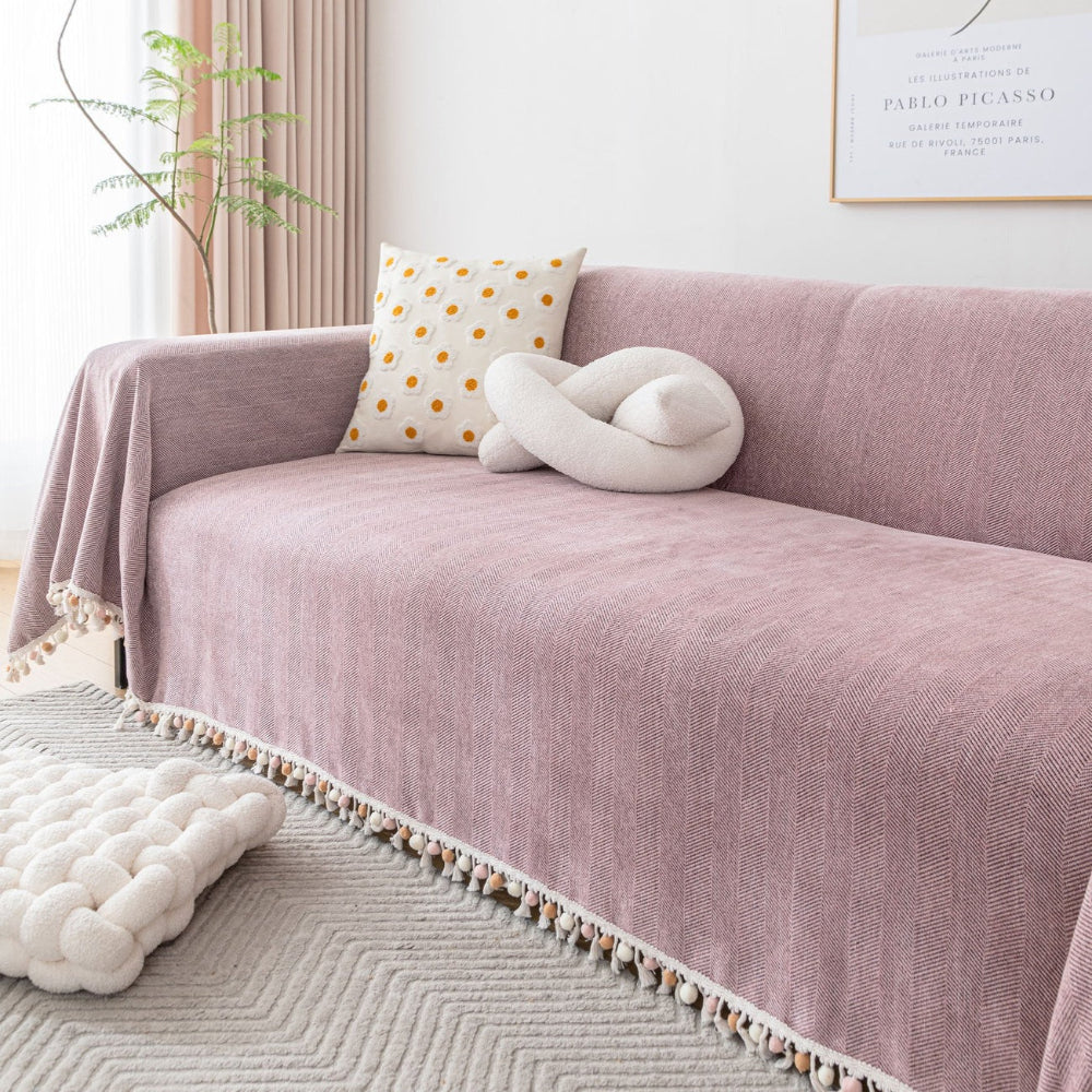 Stylish pet friendly sofa cover with herringbone weave and tassels, perfect for bohemian home decor.